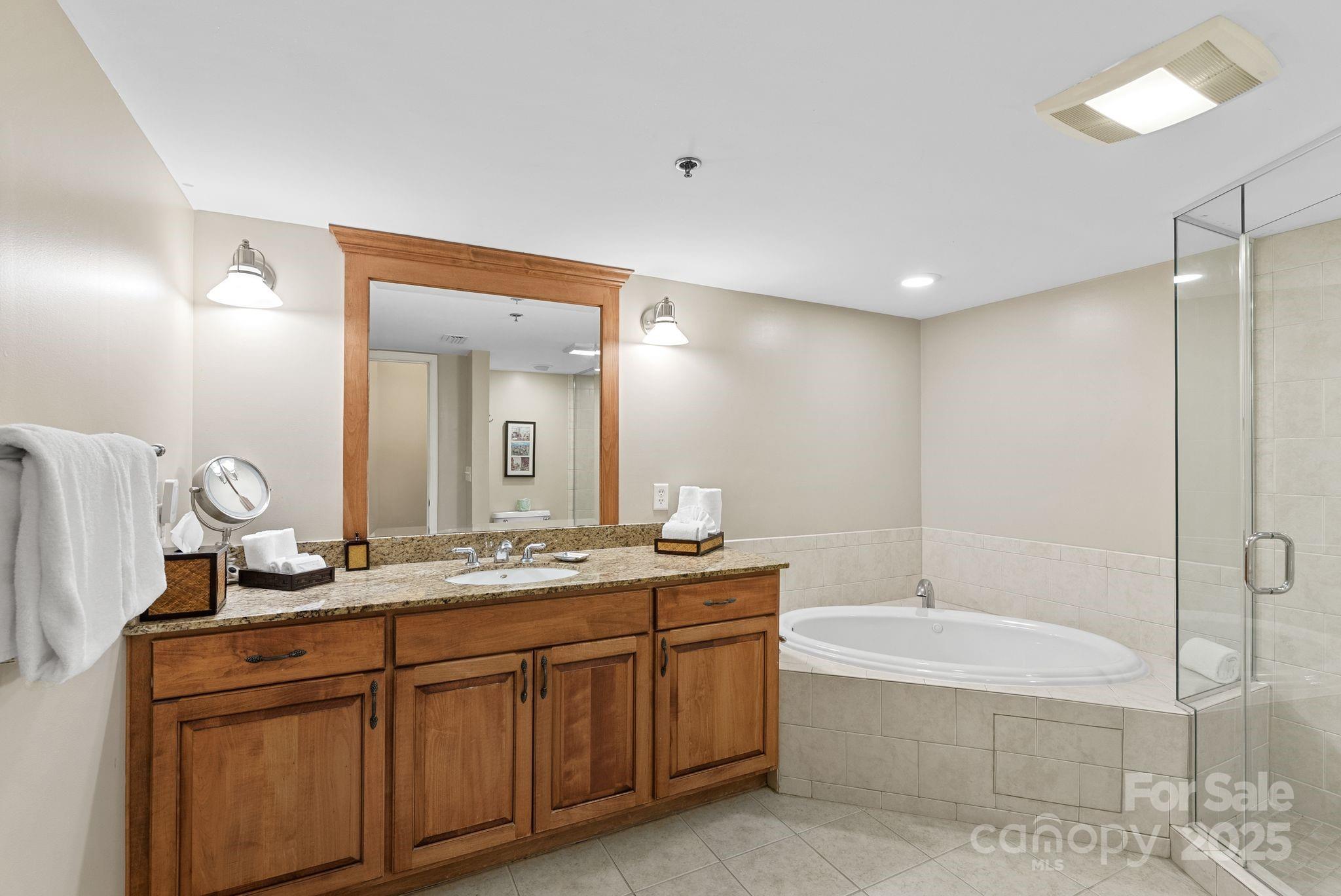 430 Bowling Park Road Asheville, NC 28803 - Photo 13 of 22 a bathroom with a granite countertop sink mirror and bathtub