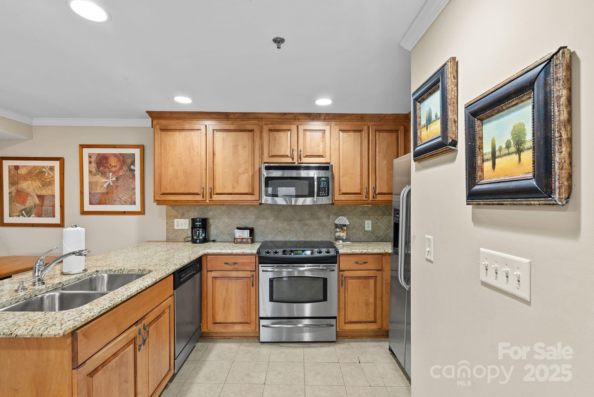 430 Bowling Park Road Asheville, NC 28803 - Photo 8 of 22 a kitchen with a stove a sink and a refrigerator