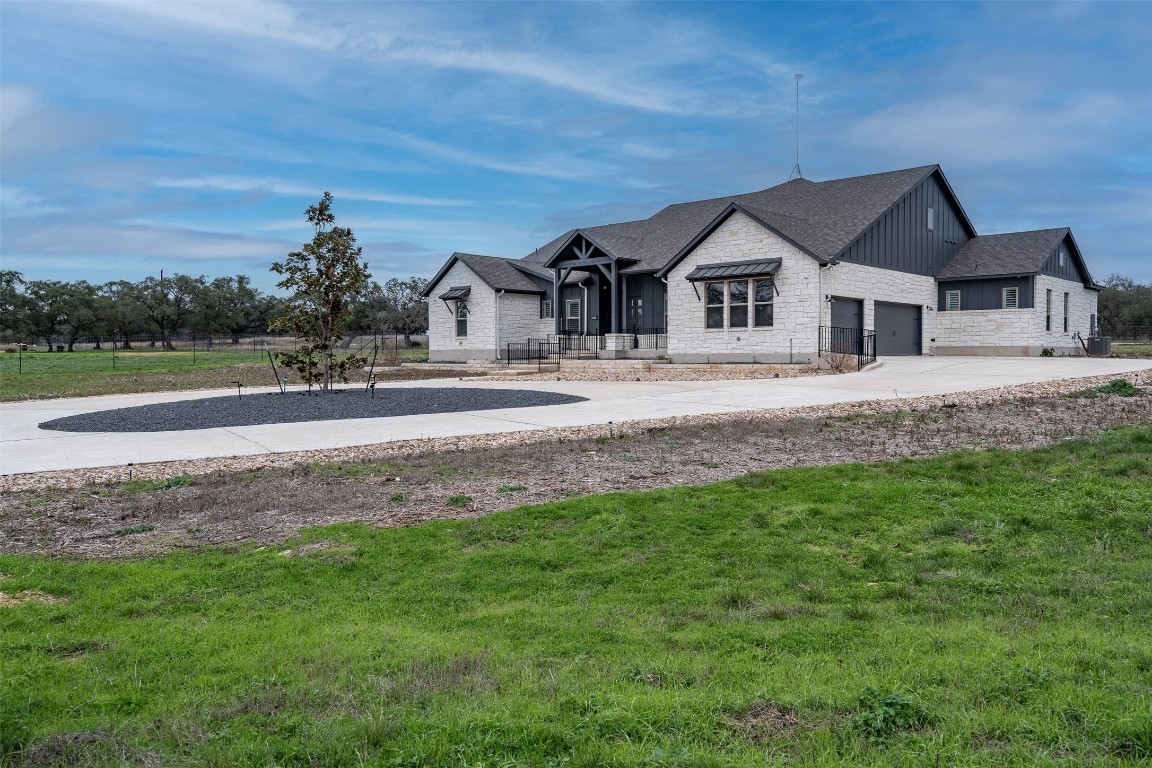 a house with green field in front of it