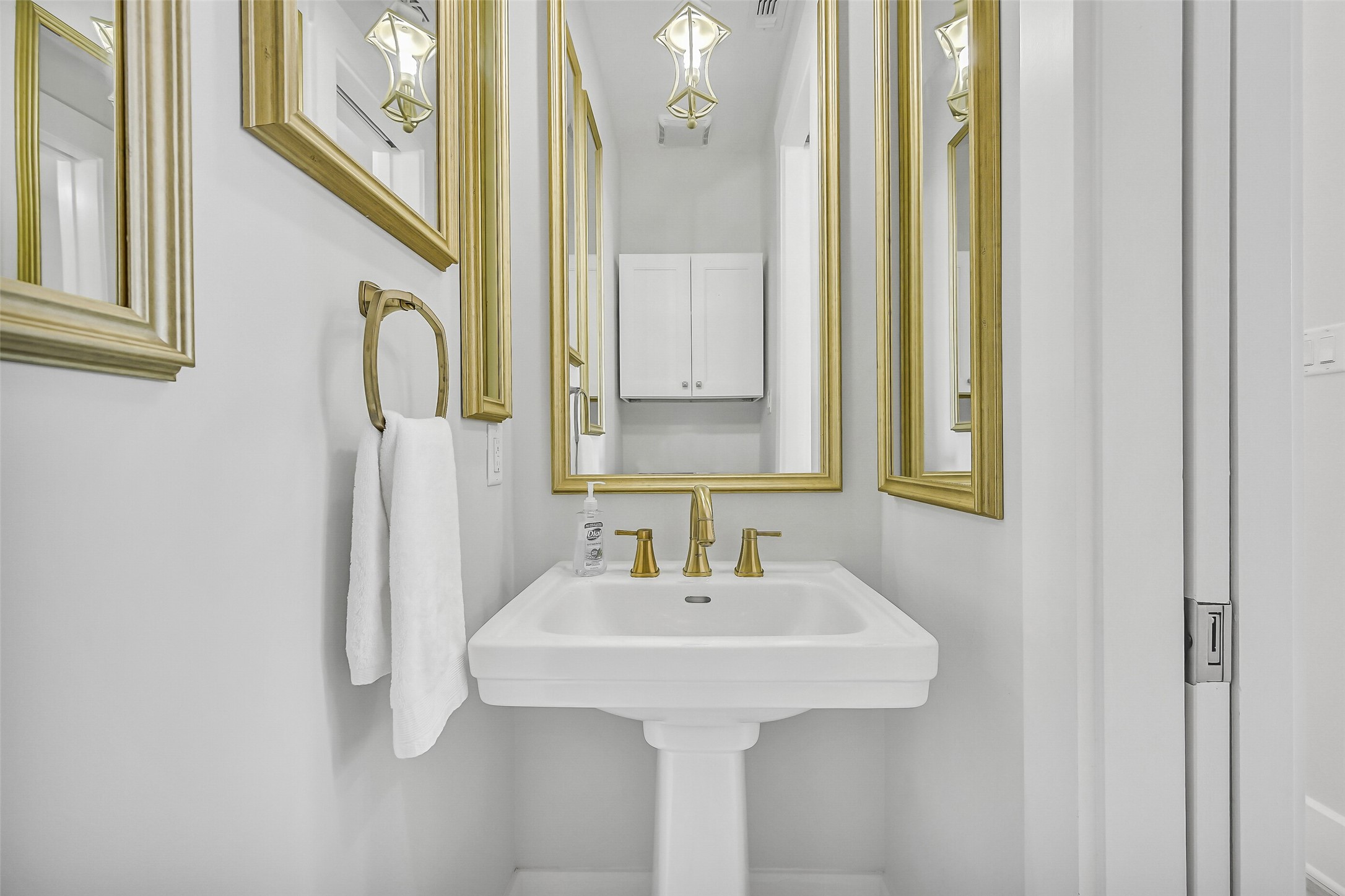 817 Positano Road Galveston, TX 77550 - Photo 22 of 50 A stylish powder room offers added convenience for guests while maintaining the home's sophisticated coastal aesthetic. Elegant finishes elevate even the smallest spaces.