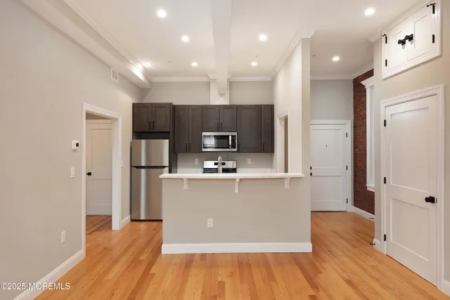 a kitchen with stainless steel appliances a refrigerator and a stove top oven