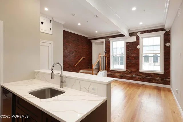 a kitchen with sink and large window