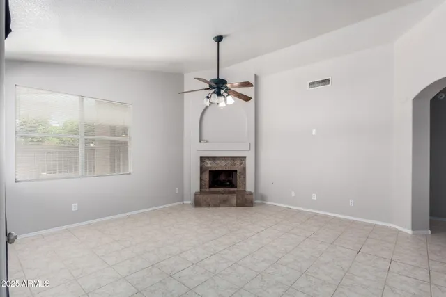a view of a livingroom with a fireplace and window