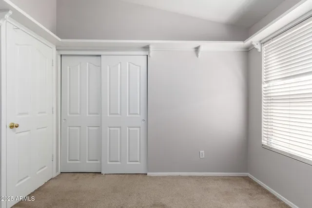 a view of an empty room with windows