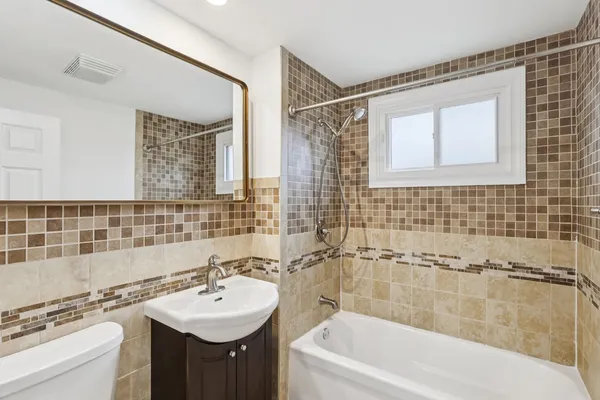 a bathroom with a sink mirror toilet and bathtub
