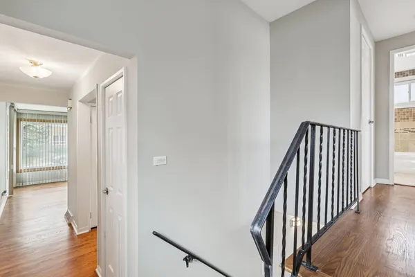 an entryway with wooden floor and stairs