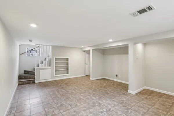 a view of an empty room with closet
