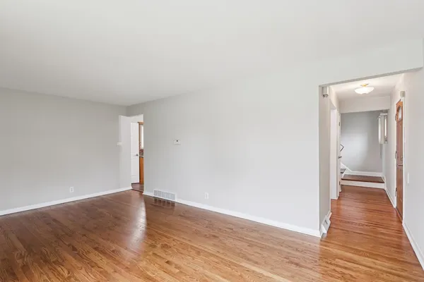 a view of a room with wooden floor