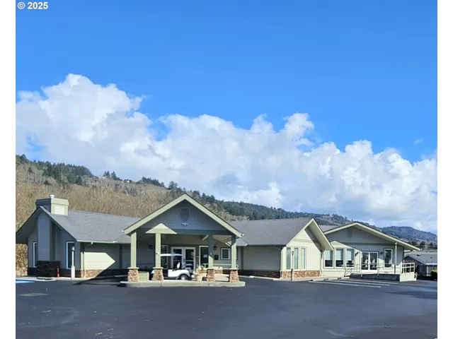 a view of a kitchen with kitchen island stainless steel appliances sink and living room view