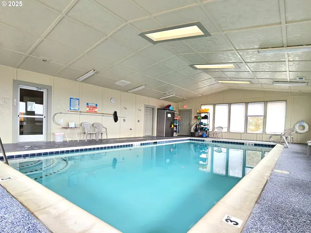 a view of a chairs and table in the backyard
