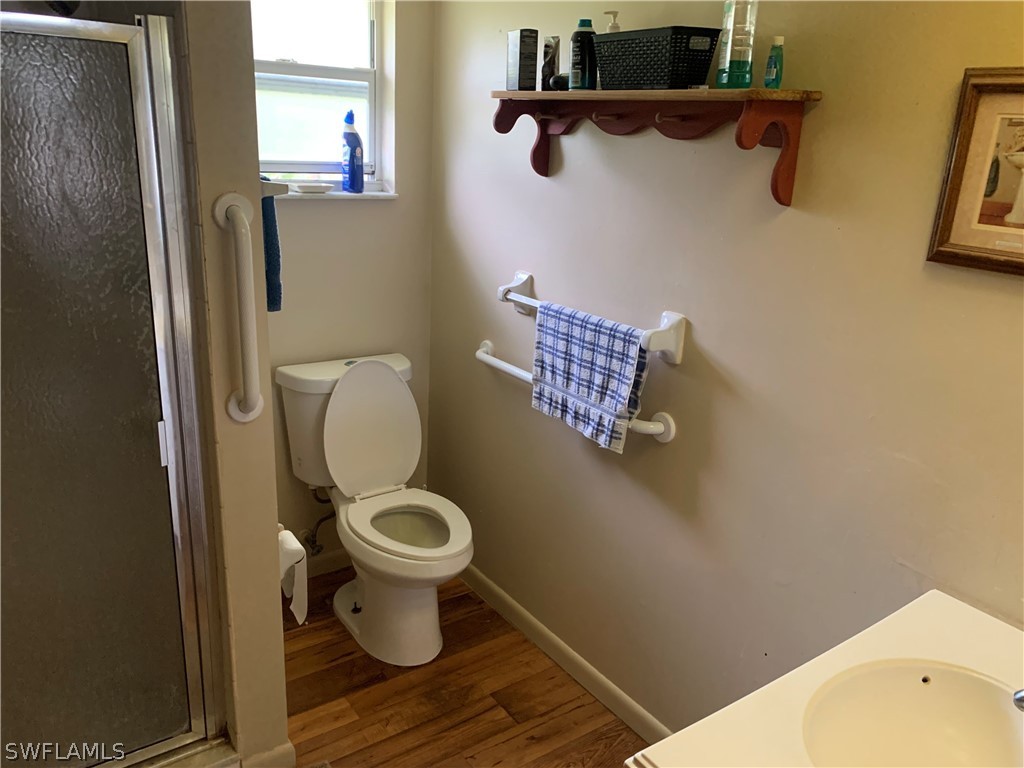 4180 Ellis Road Fort Myers, FL 33905 - Photo 19 of 26 a toilet sitting in a bathroom next to a sink