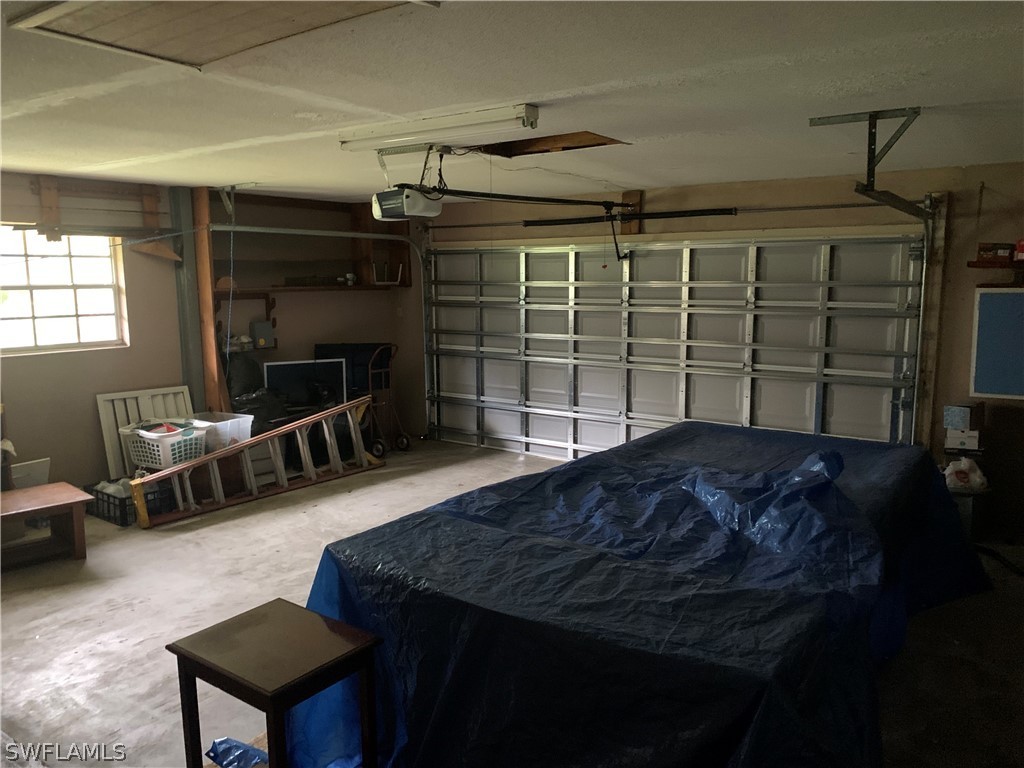 4180 Ellis Road Fort Myers, FL 33905 - Photo 20 of 26 a bedroom with a bed a desk and chair