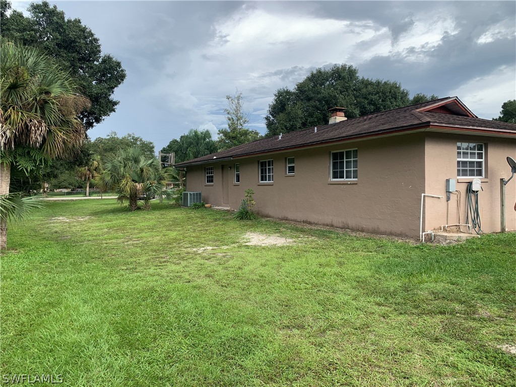4180 Ellis Road Fort Myers, FL 33905 - Photo 25 of 26 a front view of house with yard and green space