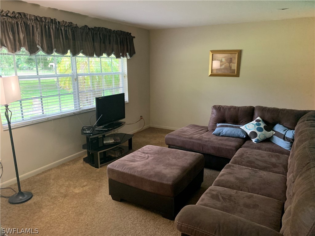 4180 Ellis Road Fort Myers, FL 33905 - Photo 3 of 26 a living room with furniture and a flat screen tv