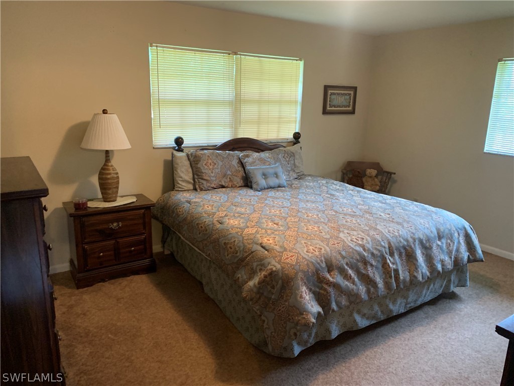 4180 Ellis Road Fort Myers, FL 33905 - Photo 7 of 26 a bed sitting in a bedroom next to a window