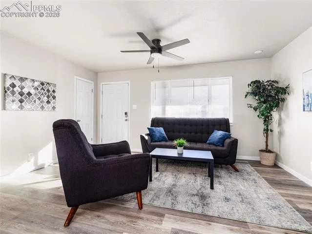 a kitchen with kitchen island granite countertop wooden floor cabinets and stainless steel appliances
