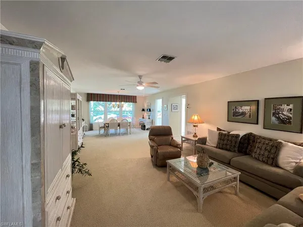 a bedroom with furniture and large windows
