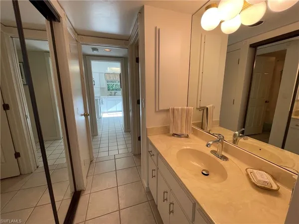 a bathroom with a sink a mirror and a shower