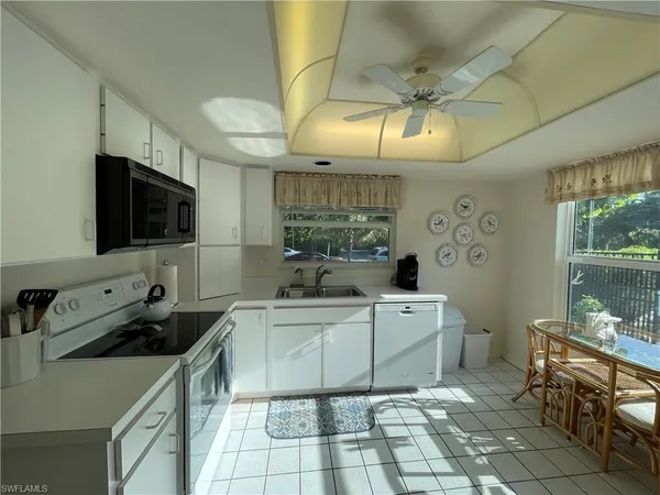 a kitchen with stainless steel appliances a sink a stove a microwave and cabinets