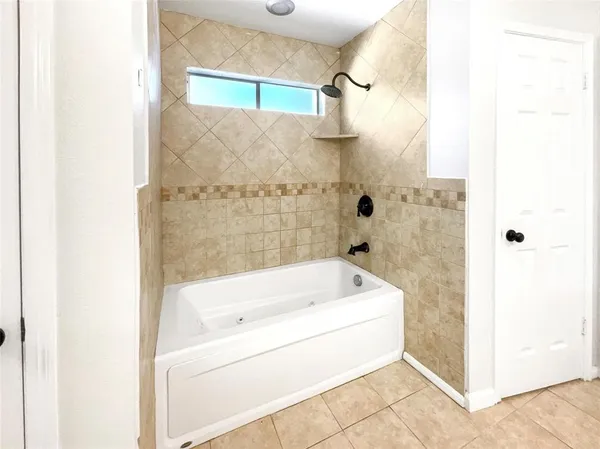 a bathroom with a tub shower and sink