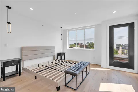 a bedroom with furniture and a window