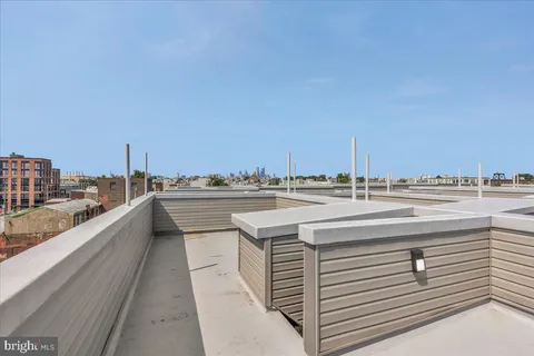 a view of a building with cars parked in front of a building