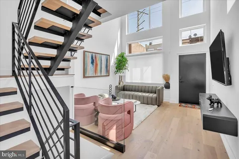 a bedroom with furniture and a large window