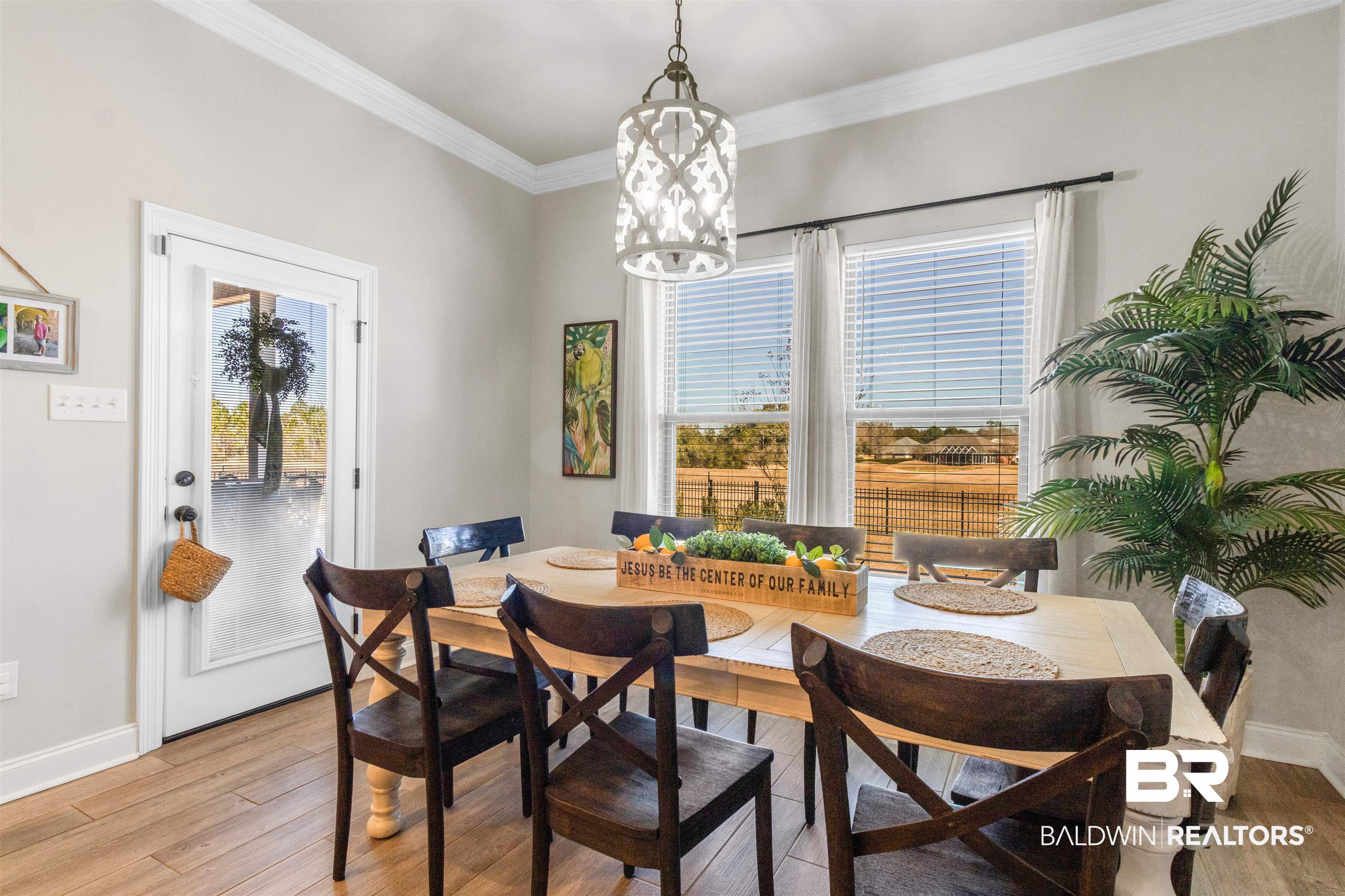 22531 Putter Lane Foley, AL 36535 - Photo 12 of 43 Dining space featuring light wood finished floors, crown molding, and a chandelier