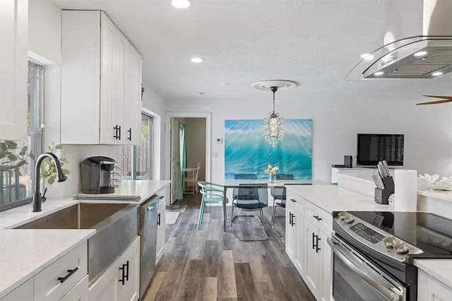 a large kitchen with a large window and stainless steel appliances