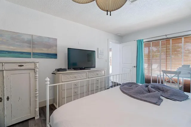 a bedroom with a bed and a flat screen tv