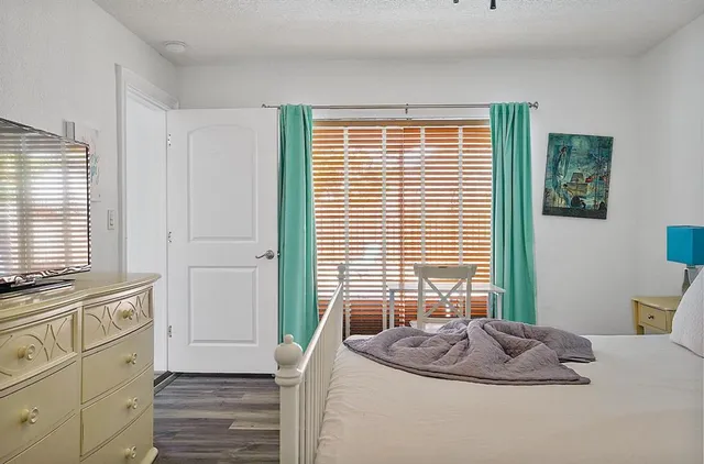 a kitchen with a window sink and wooden floor