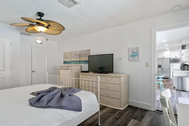 a bedroom with a bed and a flat screen tv