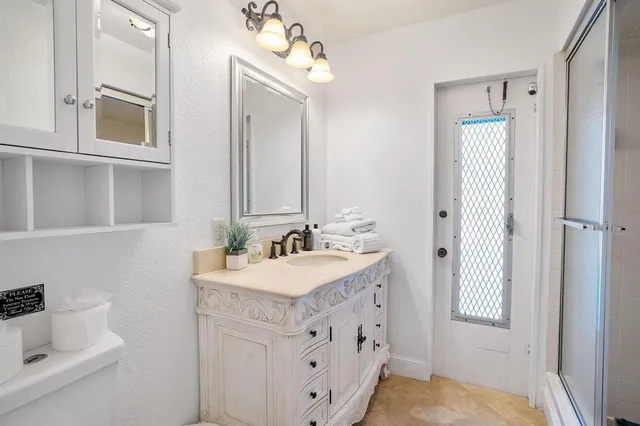 a bathroom with a sink double vanity and a mirror