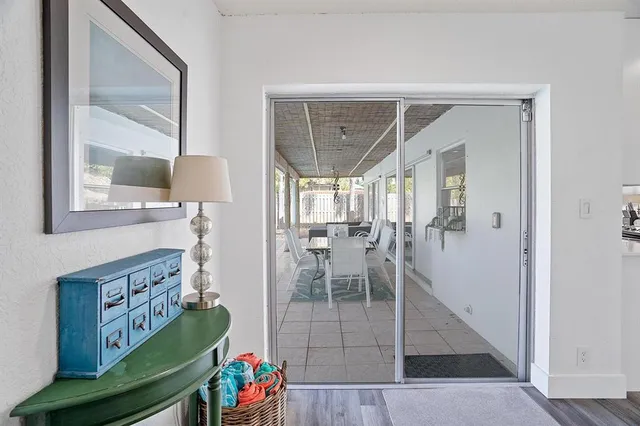a living room with furniture and a painting on the wall
