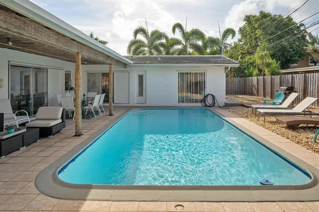 a view of a house with backyard and sitting area