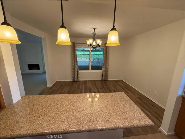 a room with pool table and windows