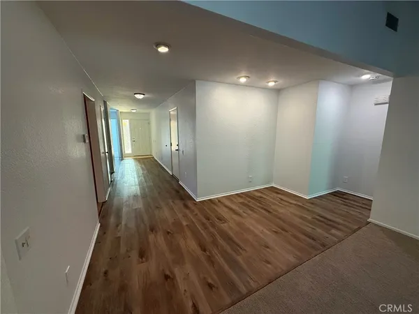 a view of hallway with wooden floor