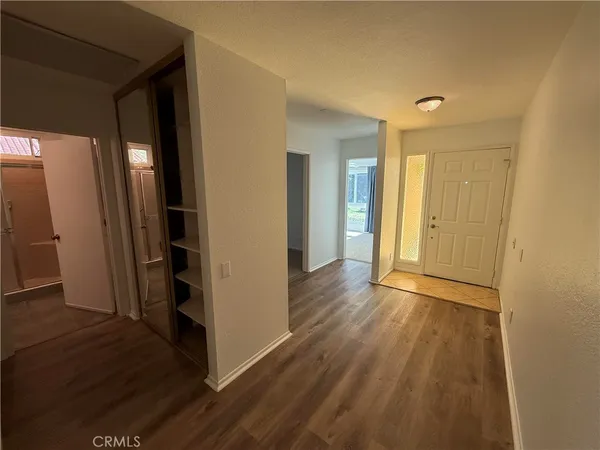 a view of a hallway with wooden floor