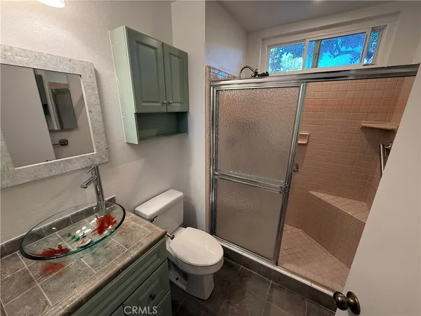 a bathroom with a toilet and a shower