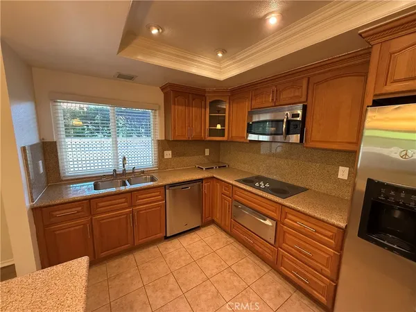 a kitchen with stainless steel appliances granite countertop a sink and stove top oven
