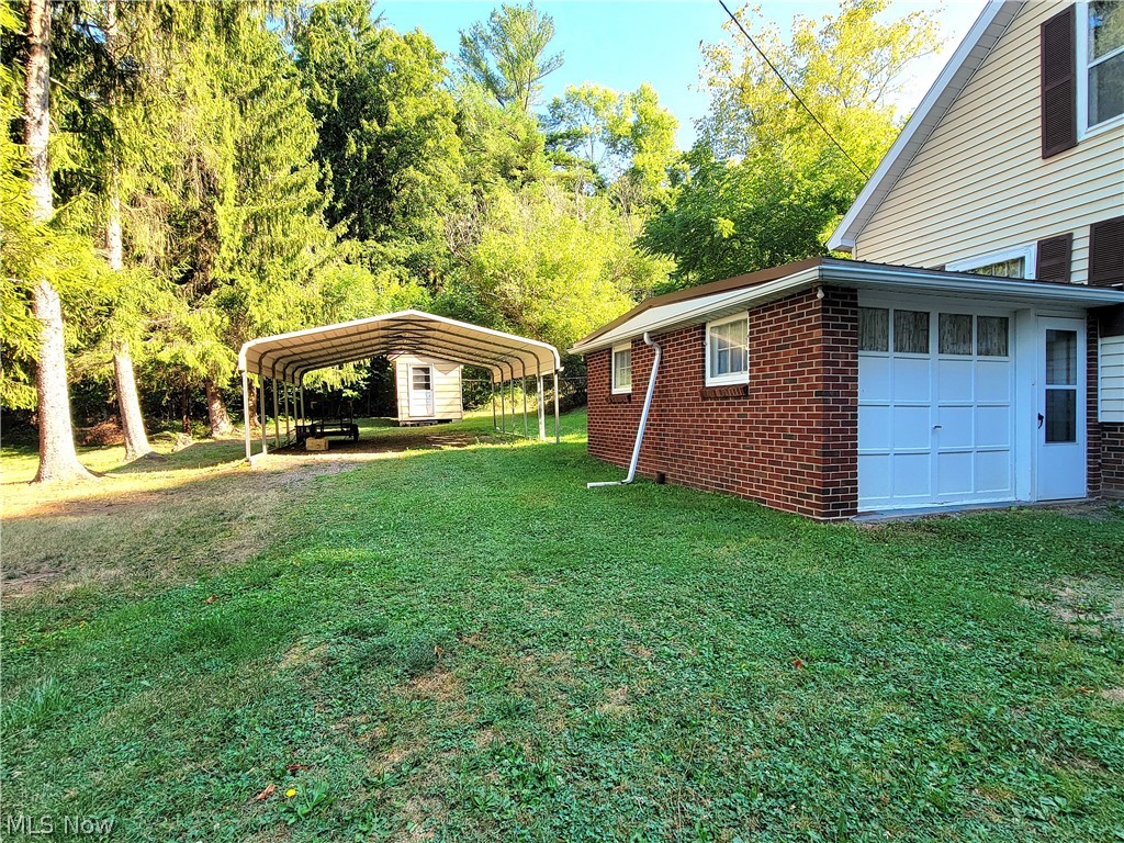 50658 Marietta Road Cumberland, OH 43732 - Photo 3 of 14 View of yard featuring a garage and a carport