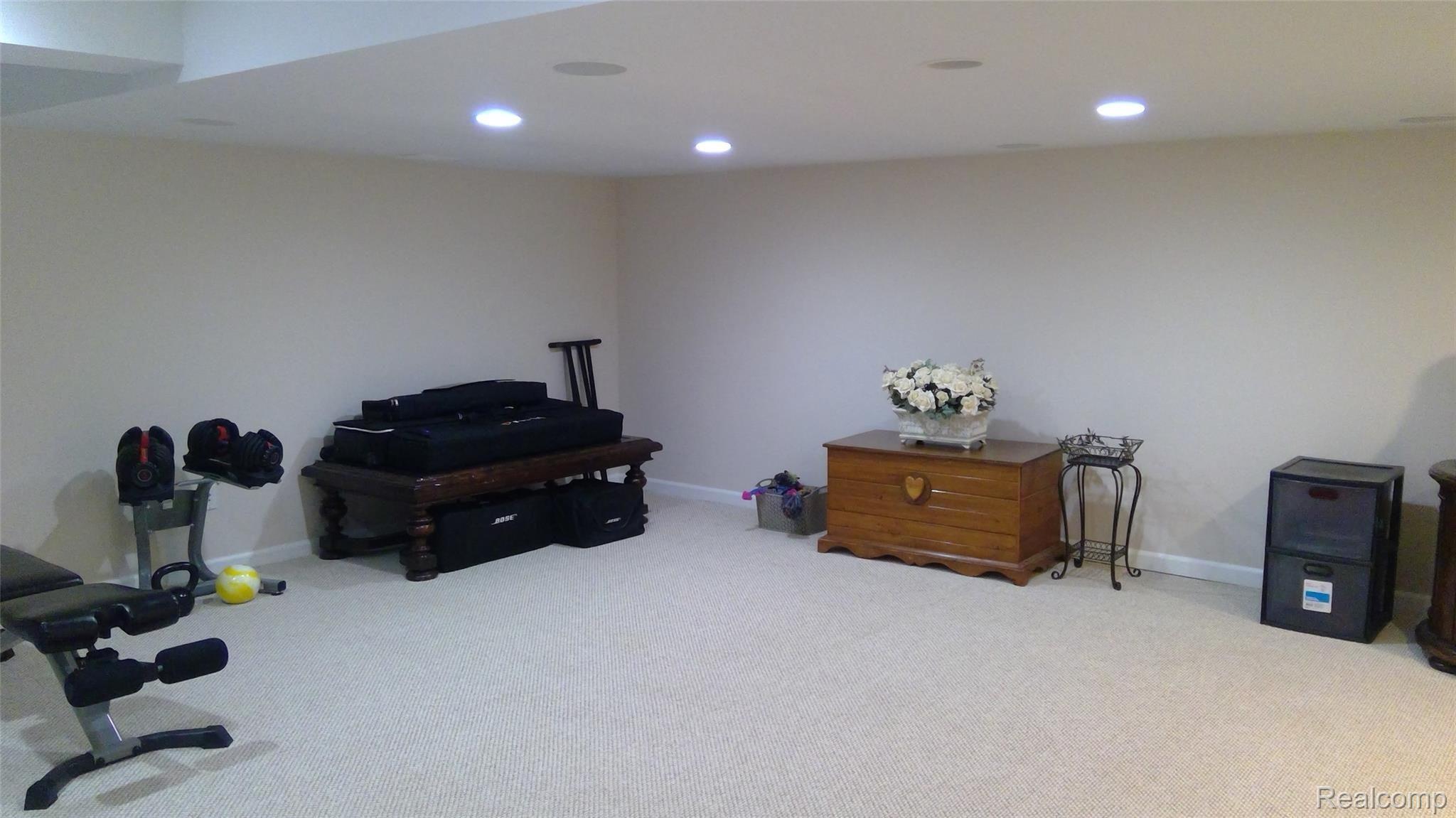 1297 Lamplighter Lane Rochester, MI 48306 - Photo 26 of 32 Finished family room in basement with carpet flooring and plenty of storage area