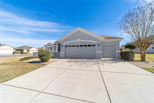 a front view of a building with a garden