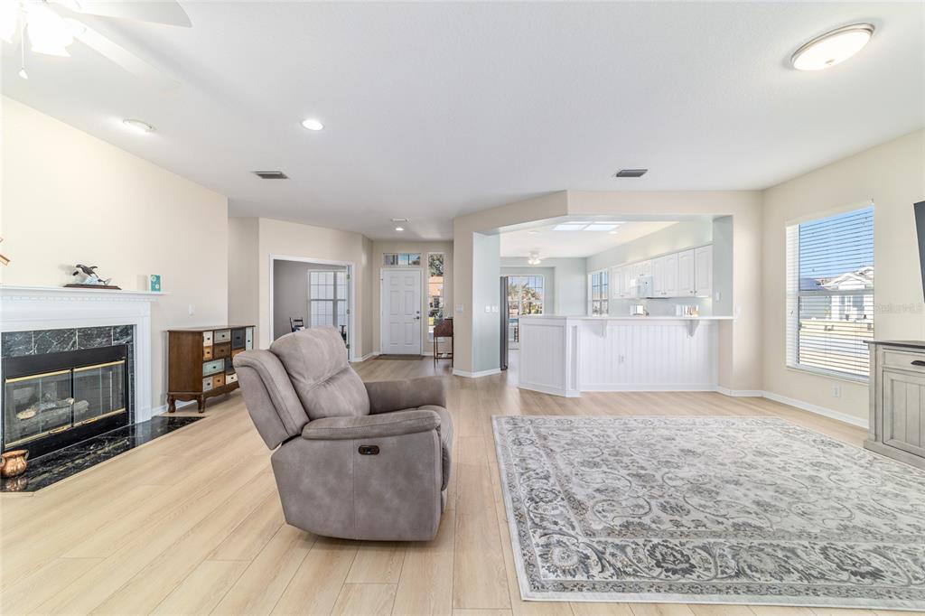 9612 Southeast 124th Loop Summerfield, FL 34491 - Photo 18 of 60 a living room with furniture and a fireplace