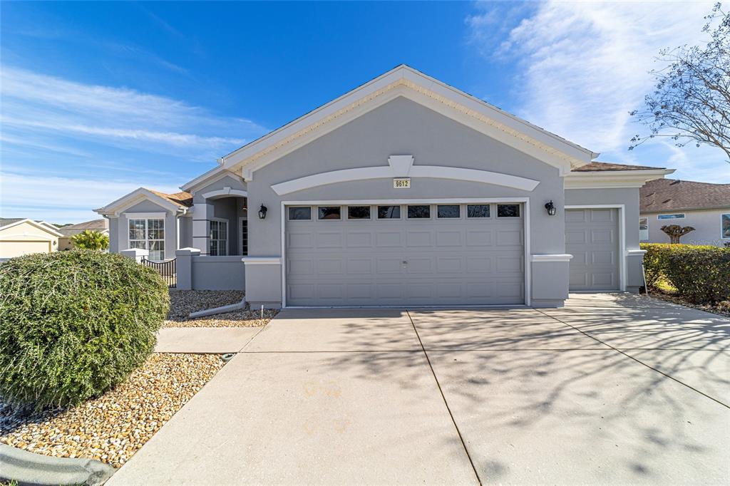 9612 Southeast 124th Loop Summerfield, FL 34491 - Photo 2 of 60 a front view of a house with a yard