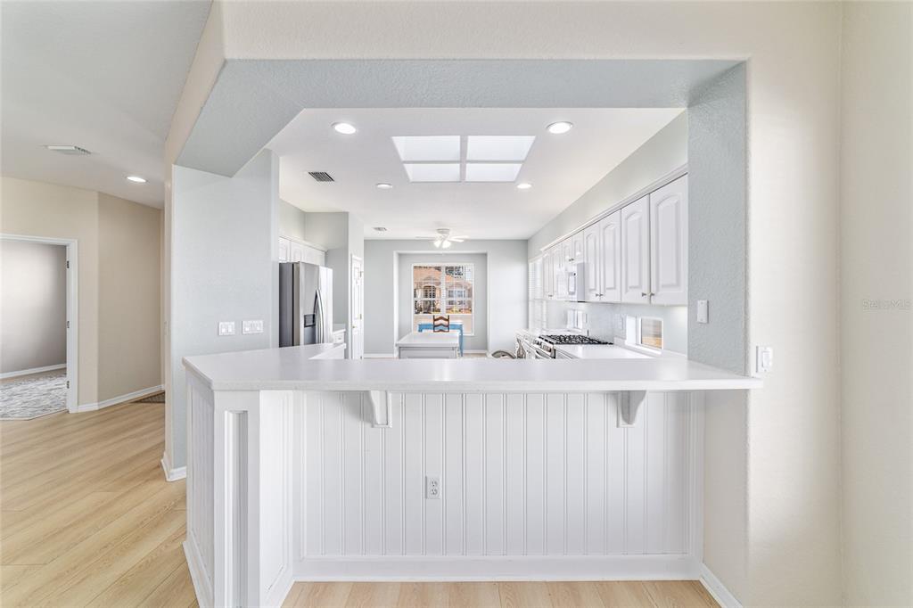 9612 Southeast 124th Loop Summerfield, FL 34491 - Photo 21 of 60 a view of a kitchen with kitchen island a sink stainless steel appliances and cabinets