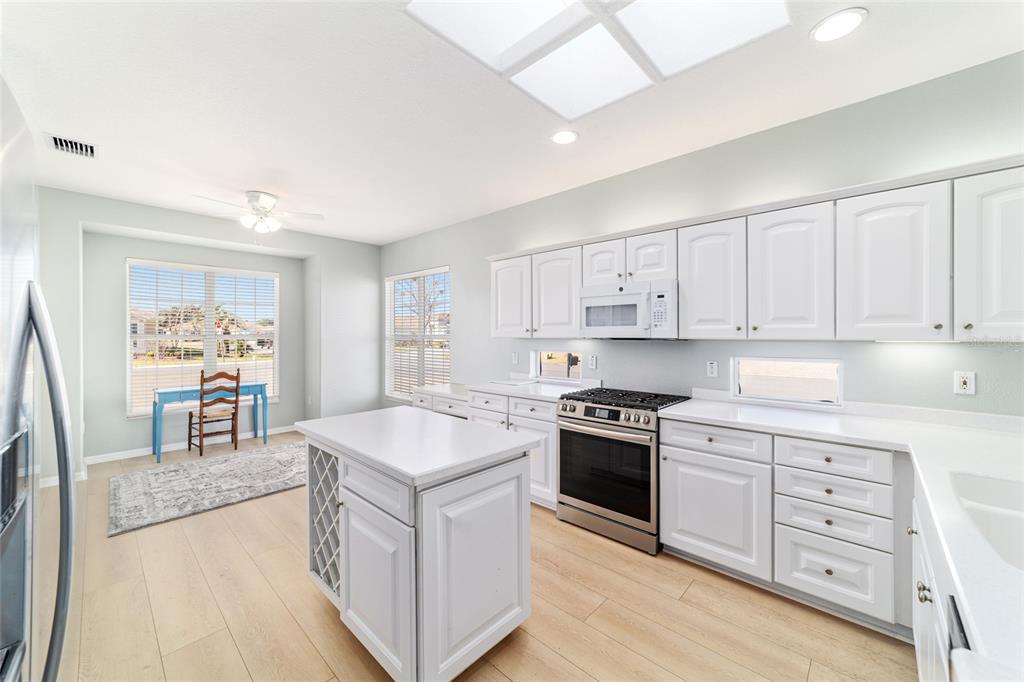 9612 Southeast 124th Loop Summerfield, FL 34491 - Photo 24 of 60 a kitchen with stainless steel appliances granite countertop a stove and a sink