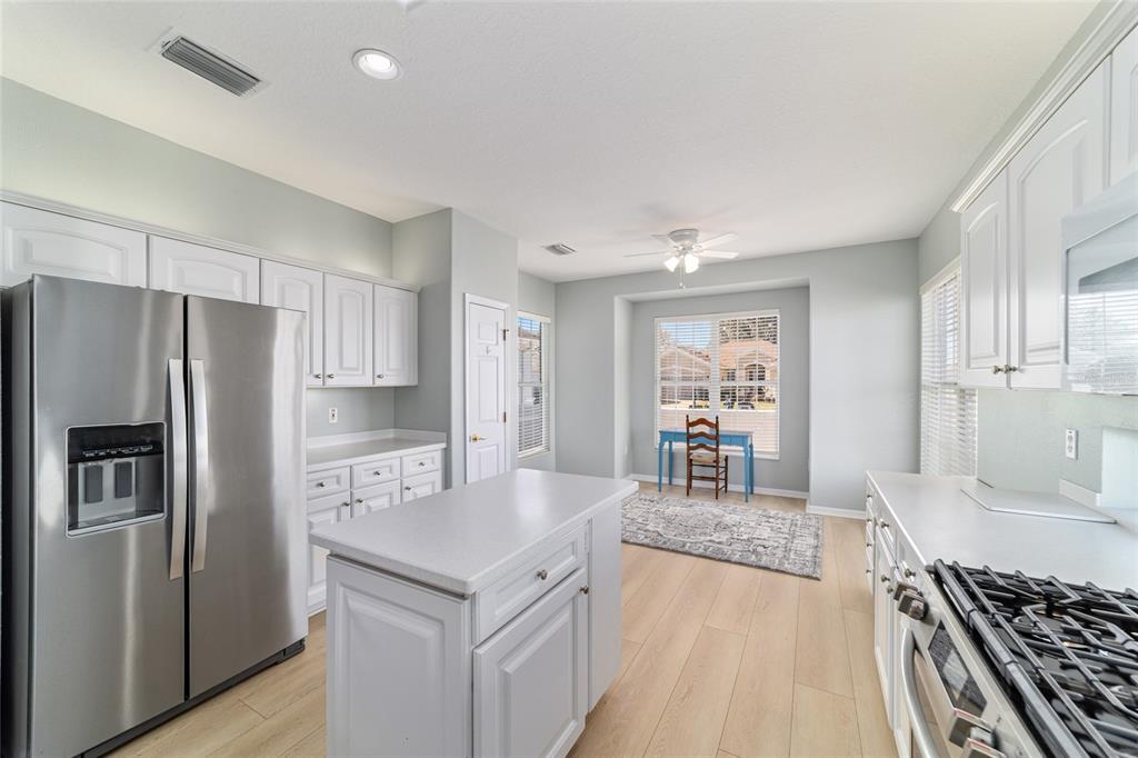 9612 Southeast 124th Loop Summerfield, FL 34491 - Photo 26 of 60 a kitchen with stainless steel appliances granite countertop a refrigerator and a stove top oven