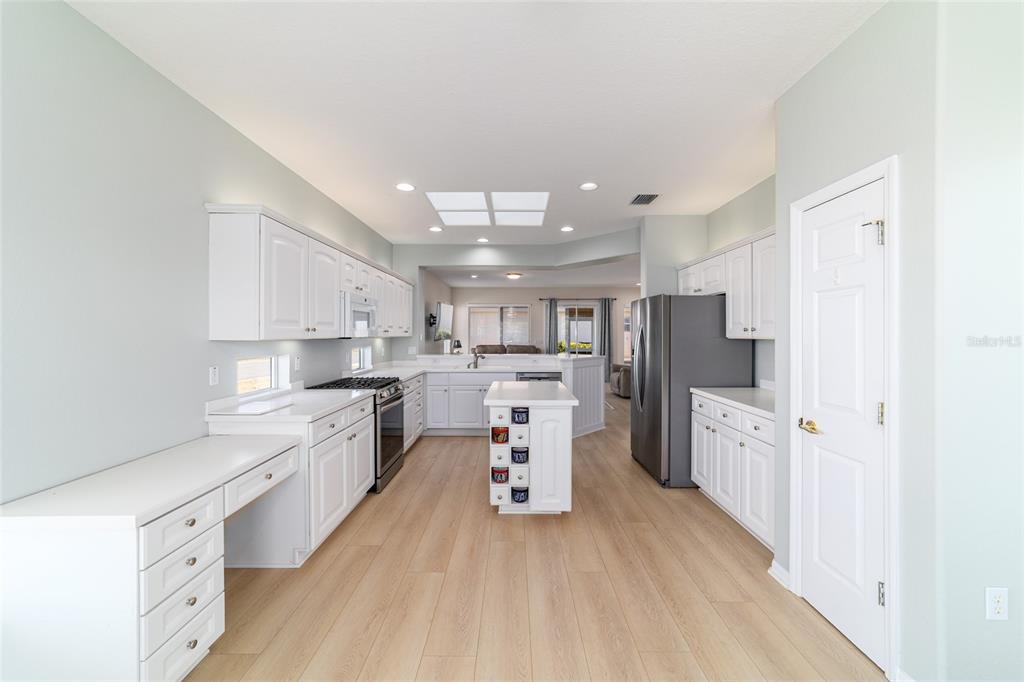 9612 Southeast 124th Loop Summerfield, FL 34491 - Photo 27 of 60 a large kitchen with stainless steel appliances lots of counter space and wooden floor