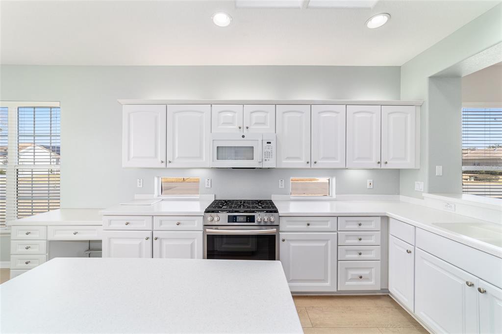 9612 Southeast 124th Loop Summerfield, FL 34491 - Photo 30 of 60 a kitchen with white cabinets and appliances